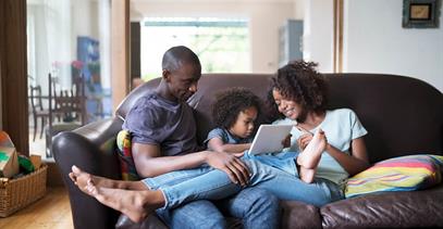 young-family-sitting-on-couch-together